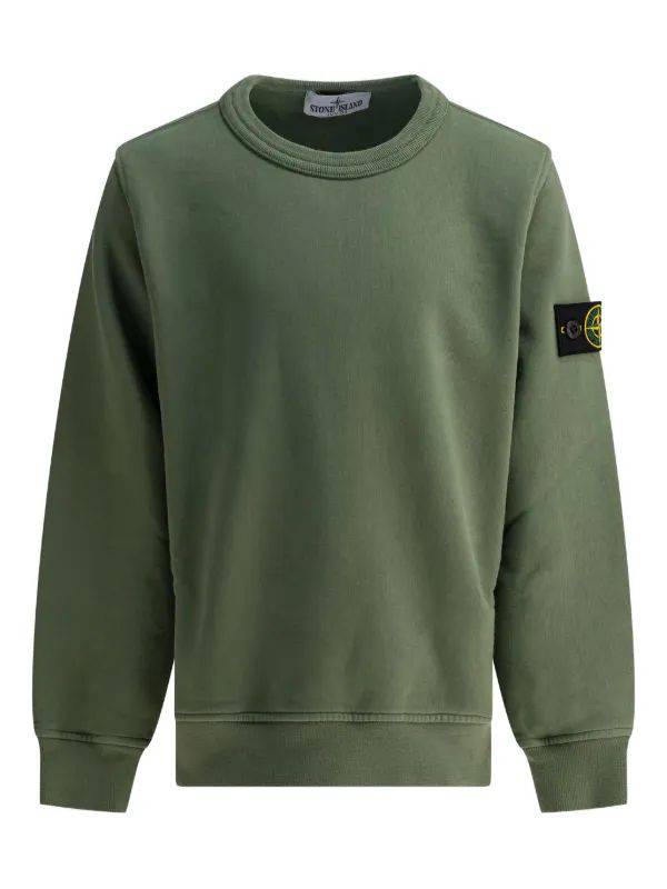 Green sweater from Brandme displayed on a hanger, showcasing its soft texture and relaxed fit.