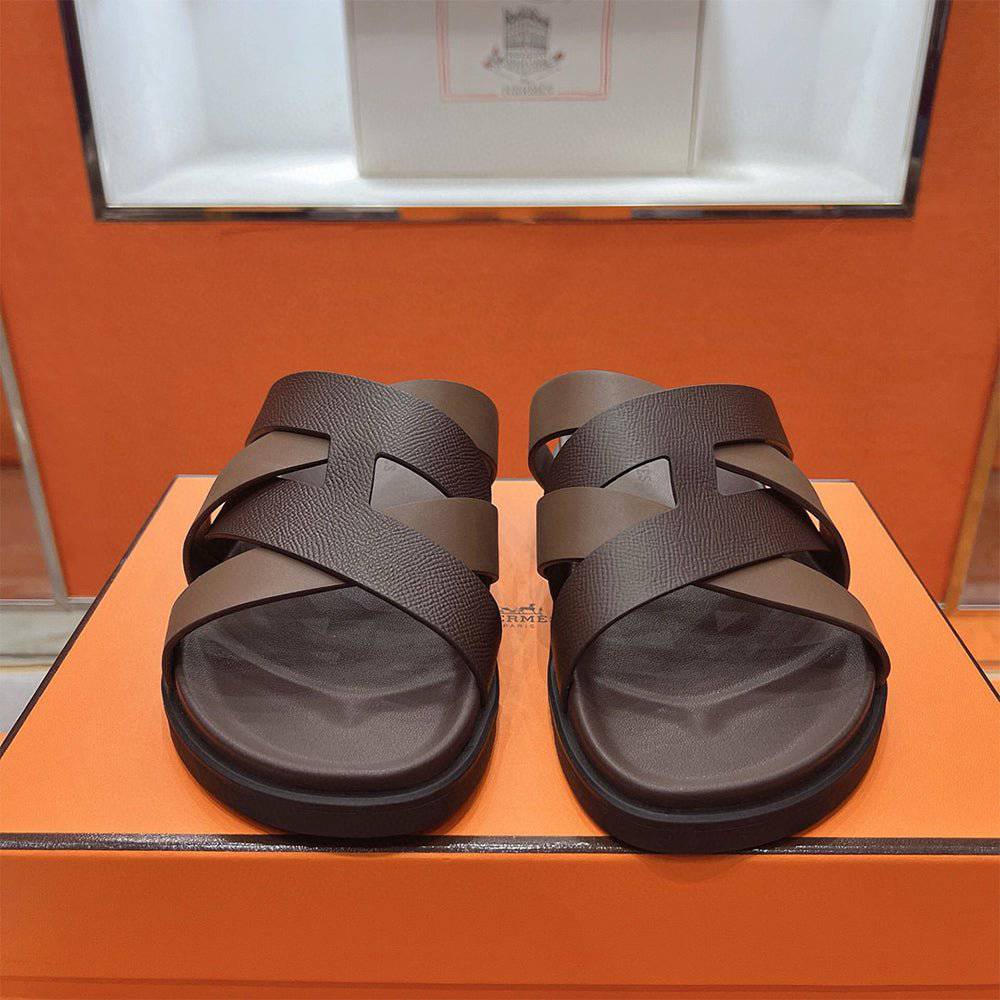 Kazimir Sandal by 24HEARTZ featuring a stylish open-toe design with straps and a comfortable flat sole.