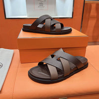 Kazimir sandal by 24HEARTZ featuring tan leather straps and flat sole, stylish open-toe design for casual summer wear.