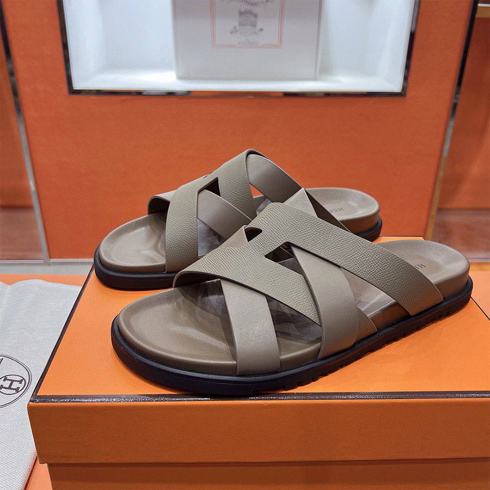 24HEARTZ Kazimir Sandal featuring a stylish open-toe design with braided straps and a comfortable flat sole.