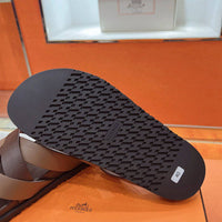 Kimazir Sandal by 24HEARTZ featuring tan leather straps and a flat sole, perfect for casual summer wear.