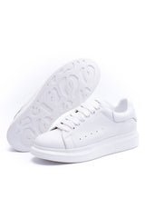24HEARTZ oversized sneaker in white with chunky sole and minimalistic design, shown from an angled top view.