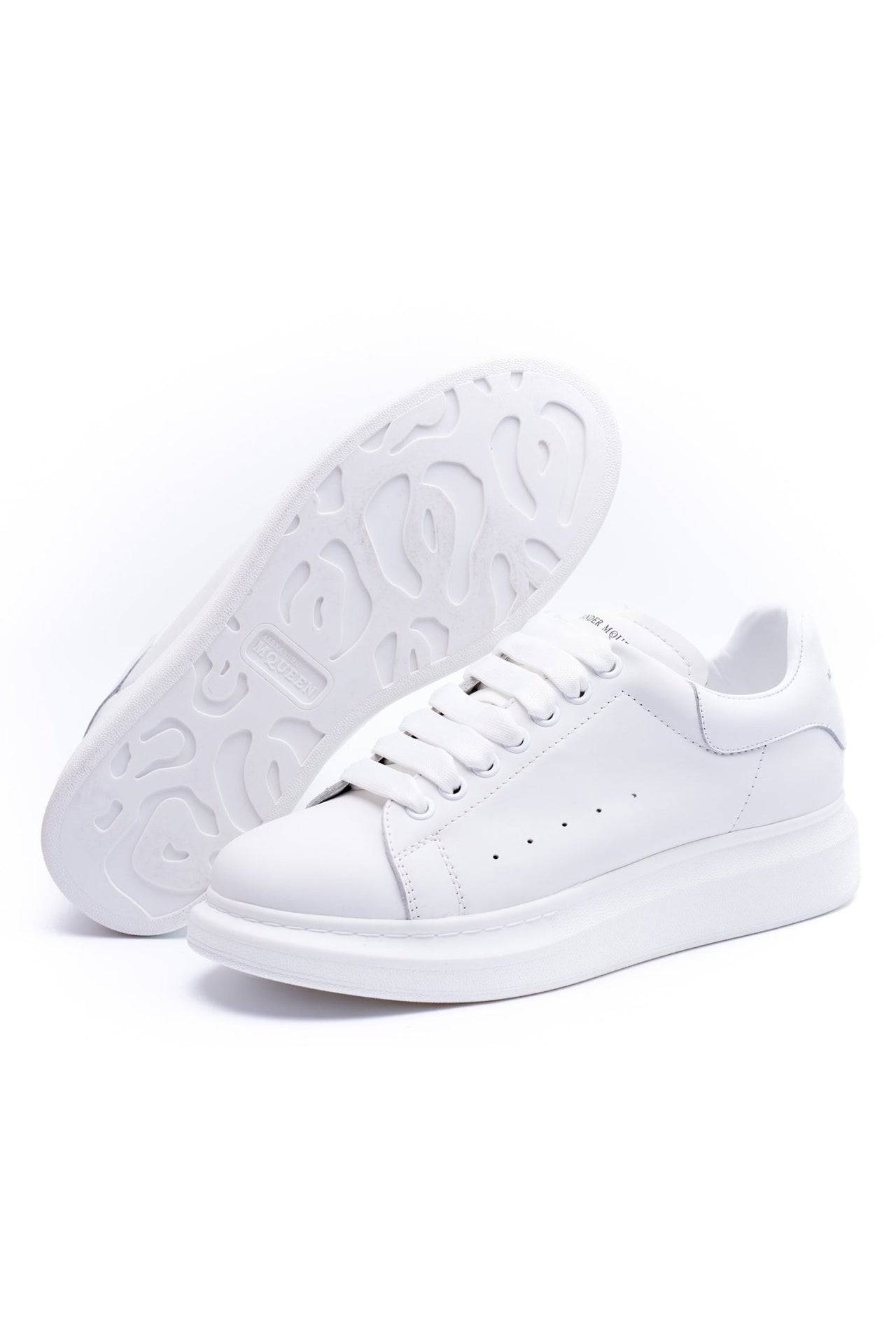 24HEARTZ oversized sneaker in white with chunky sole and minimalistic design, shown from an angled top view.