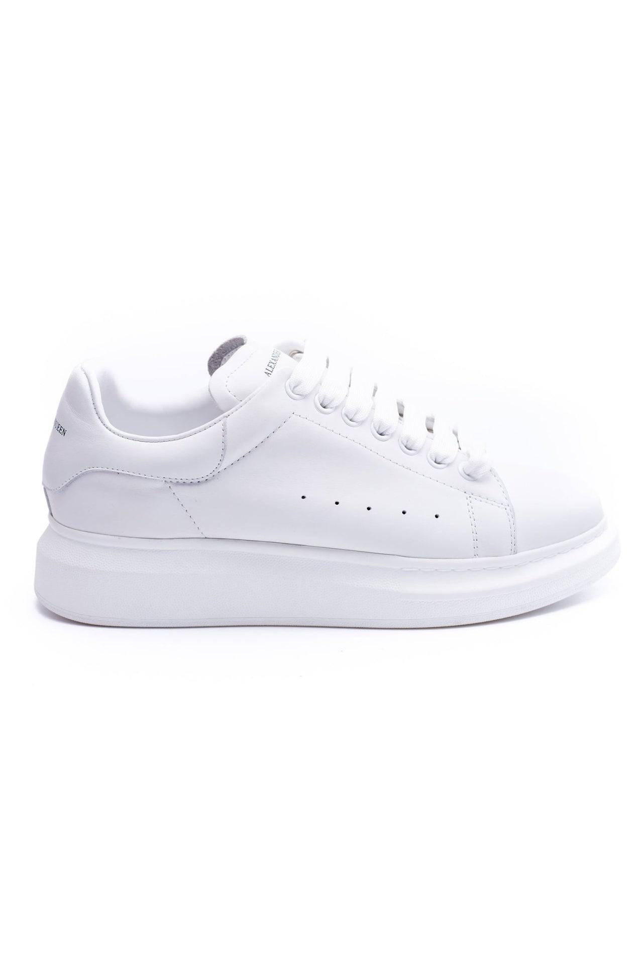 24HEARTZ oversized sneaker in white with chunky sole and lace-up design, displayed from a side angle.